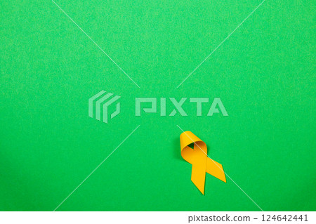 Yellow ribbon symbolizes hope and support in cancer awareness campaigns 124642441