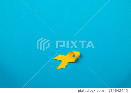 Yellow ribbon symbolizes hope and support in the fight against cancer 124642443