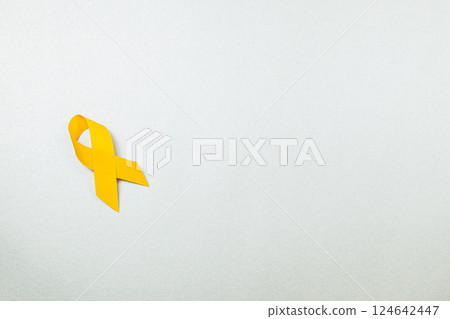 Yellow ribbon symbolizes hope and support for cancer awareness campaign 124642447