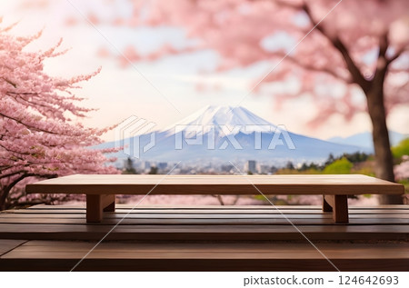 A lone wooden table set in a Sakura garden, surrounded by soft pink petals floating in the air. A lone wooden table set in a Sakura garden, surrounded by soft pink petals floating in the air. 124642693