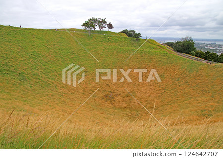 The crater of an extinct volcano that has turned into grassland The crater of an extinct volcano that has turned into grassland 124642707