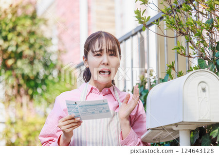 Woman surprised at meter reading chart: electricity, gas, water bills 124643128