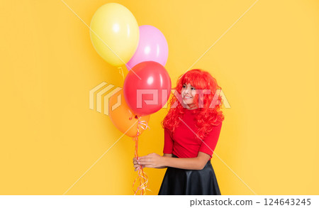 cheerful kid with party balloon on yellow background 124643245
