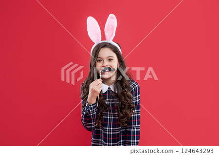 happy child girl in easter bunny ears and party moustache having fun, easter party 124643293