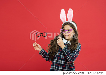 Rabbit fashion style. spring family holiday. little cute bunny. child with party glasses. having fun. amazed kid wear bunny ears. girl in Easter bunny during egg hunt. party and child concept Rabbit fashion style. spring family holiday. little cute bunny. child with party glasses. having fun. amazed kid wear bunny ears. girl in Easter bunny during egg hunt. party and child concept 124643294