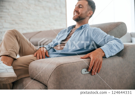 Sitting and enjoying. Customer visiting the sofa and bed store. Looking for update 124644331