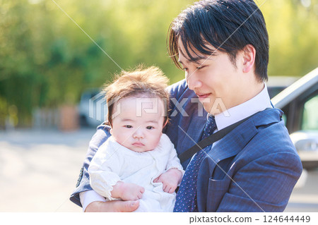 Man holding a baby at shrine visit 124644449