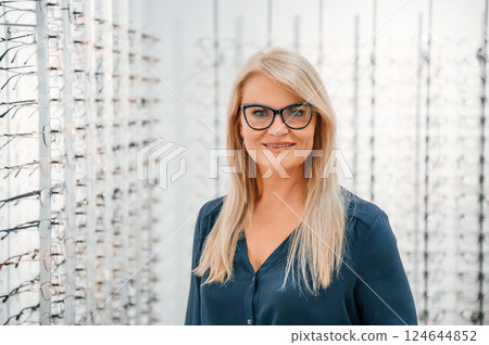 Wearing the glasses. Woman is in the store 124644852