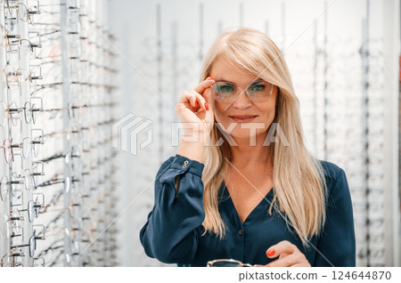 Portrait of woman that is in the store trying new glasses 124644870
