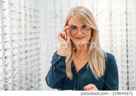 Portrait of woman that is in the store trying new glasses 124644871