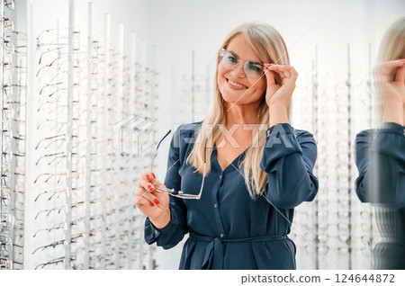 Portrait of woman that is in the store trying new glasses 124644872