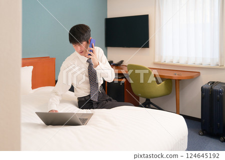 A businessman working in a hotel on a business trip 124645192