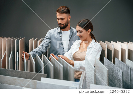 Big choice of products. Woman and man is in the store of goods for the home 124645252