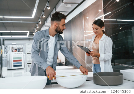 Two people is in the store of goods for the home 124645303