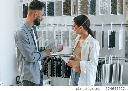Standing and looking for new materials for home. Woman and man is in the store of goods 124645632