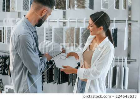 Standing and looking for new materials for home. Woman and man is in the store of goods 124645633