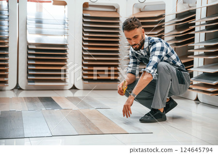 Man in grey uniform is with parquet indoors 124645794