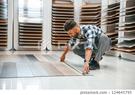 Man in grey uniform is with parquet indoors 124645795