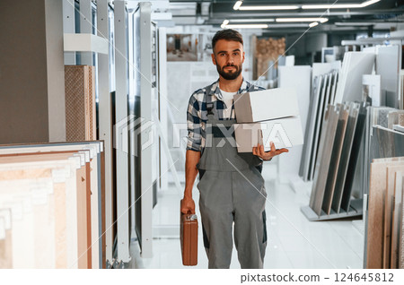 With equipment. Stylish beautiul man is in the store of goods for the home 124645812