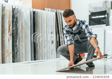 Man in grey uniform is with parquet indoors 124645830