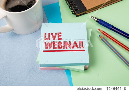 Live Webinar Announcement on Desk with Stationery 124646348