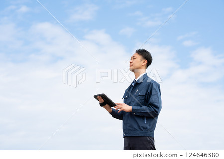 Male employee holding a tablet Male employee holding a tablet 124646380