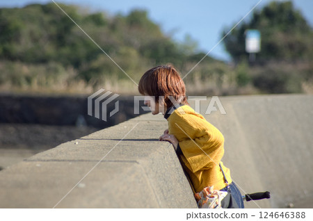 <People> A woman walking along the seaside (along the embankment) <People> A woman walking along the seaside (along the embankment) 124646388