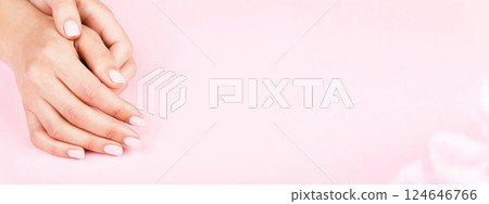 Banner with female's hands with classic pastel manicure on pink background. Beauty salon. Banner with female's hands with classic pastel manicure on pink background. Beauty salon. 124646766