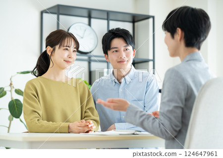 Young couple consulting planner Young couple consulting planner 124647961