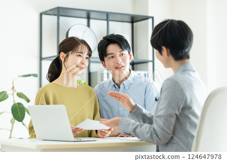 Young couple consulting planner Young couple consulting planner 124647978