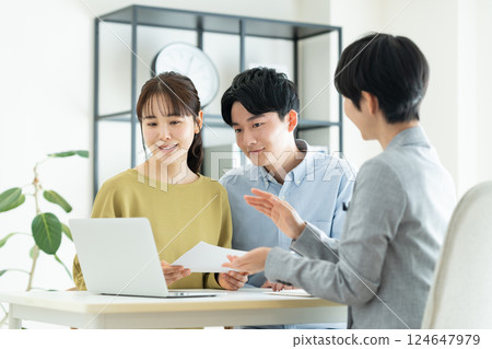 Young couple consulting planner Young couple consulting planner 124647979