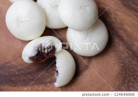 Cross-section of a bite-sized bun filled with bean paste, split in half Cross-section of a bite-sized bun filled with bean paste, split in half 124648066