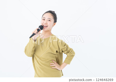 Young woman singing karaoke Young woman singing karaoke 124648269