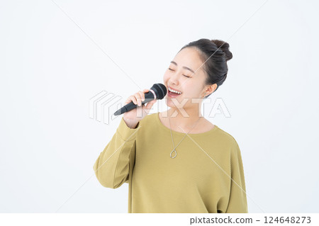 Young woman singing karaoke Young woman singing karaoke 124648273