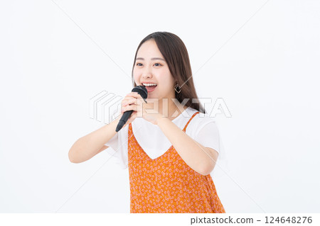 Young woman singing karaoke Young woman singing karaoke 124648276