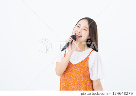 Young woman singing karaoke 124648279