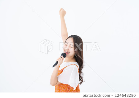 Young woman singing karaoke 124648280
