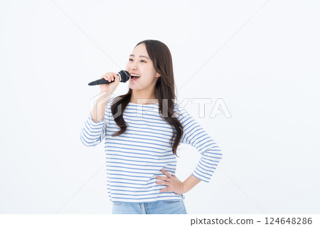 Young woman singing karaoke Young woman singing karaoke 124648286