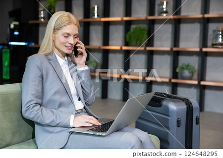 Pretty blonde elegant business woman with a phone in hand 124648295
