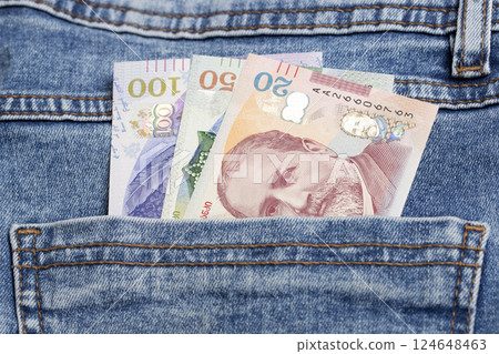 Georgian Lari in the pocket of blue jeans Georgian Lari in the pocket of blue jeans 124648463