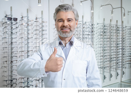 Smiling bearded mature man in lab coat feeling contented and successful 124648659