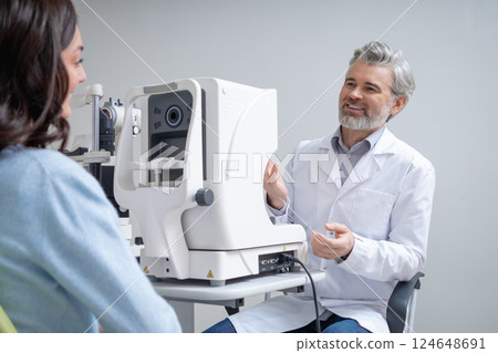 Woman visiting optical clinic for eyesight test with ophthalmologist 124648691