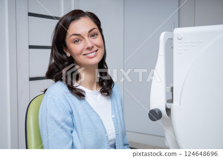Female patient visiting optical center for eyesight measurement 124648696