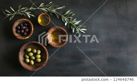Variety of Olives and Olive Oil in Wooden Bowls on Rustic Banner 124648746