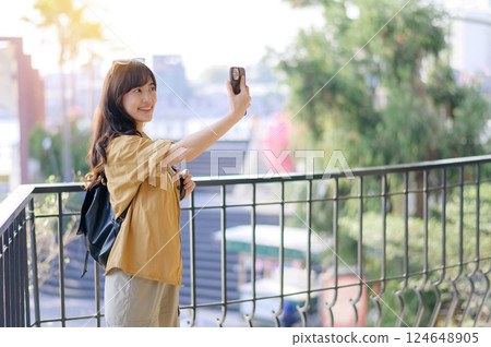 Traveler young asian woman in her 30s navigates the vibrant streets of Bangkok. Let this photo inspire your own journey. Traveler young asian woman in her 30s navigates the vibrant streets of Bangkok. Let this photo inspire your own journey. 124648905