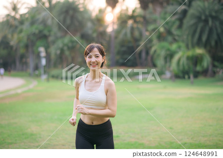 sportswoman with white sportswear in public park. 124648991