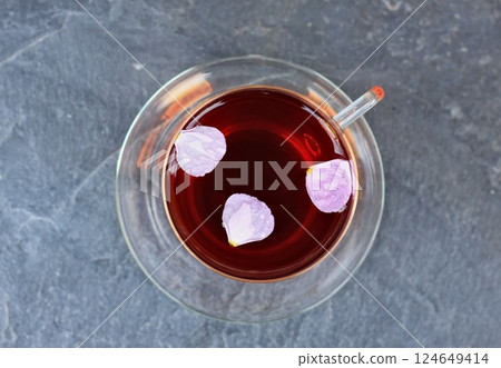 Cup of herbal infusion from Cistus incanus, known as rock rose with its pink petals. 124649414