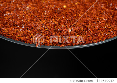 Ground red chili on a plate, space for text 124649952