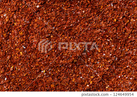Spicy ground chili pepper close-up texture top view 124649954