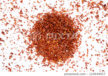 Hot chili peppers crushed and dried, natural seasoning on a white background Hot chili peppers crushed and dried, natural seasoning on a white background 124649957